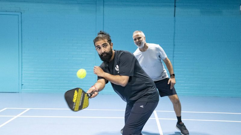 2 people playing Pickleball